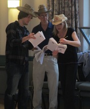Cast members go over their scripts before rehearsal begins
