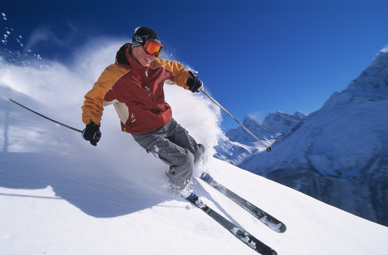 Man performing skiing tricks in epic pass snowy mountain