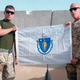 Tim Harvey of Blackstone left in Afghanistan in 2011 holds MA flag given him by State Senator Richard Moore